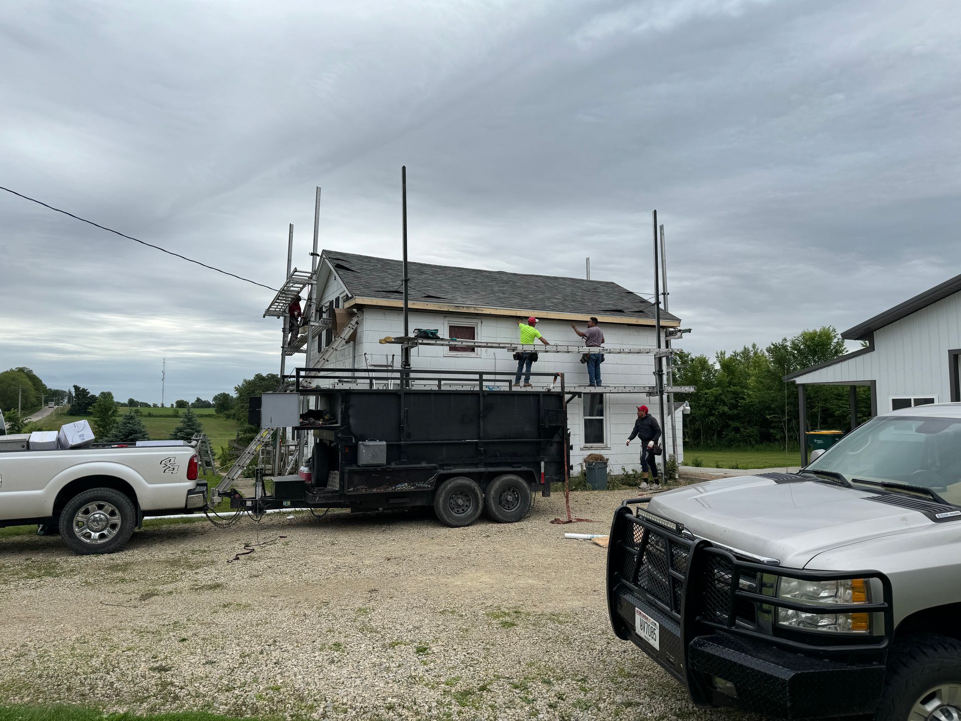 A truck is parked in front of a house under construction.