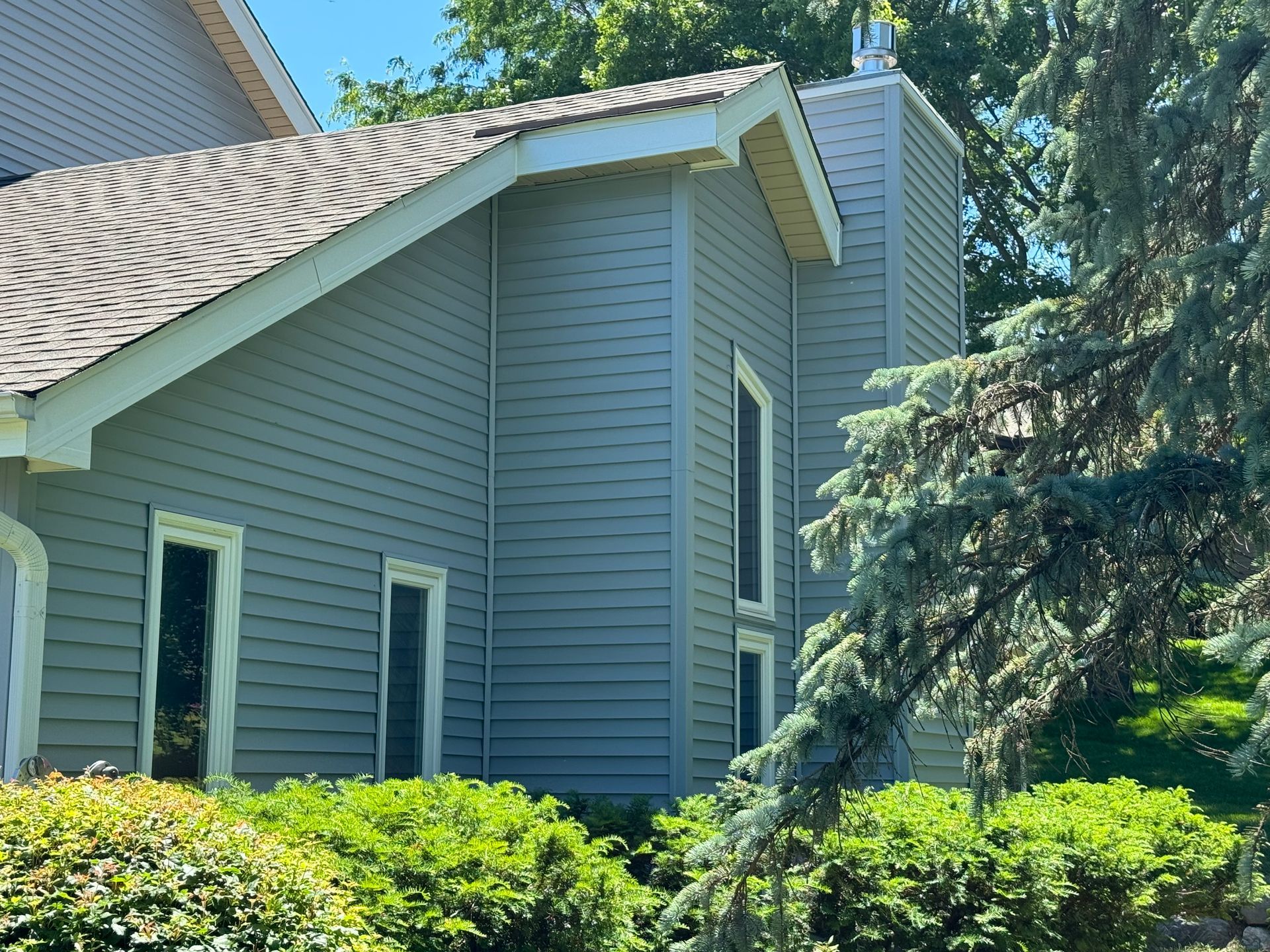 A large house with a roof and a lot of windows