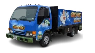 Blue delivery truck with GRO-PRO branding and colorful graphics on the side