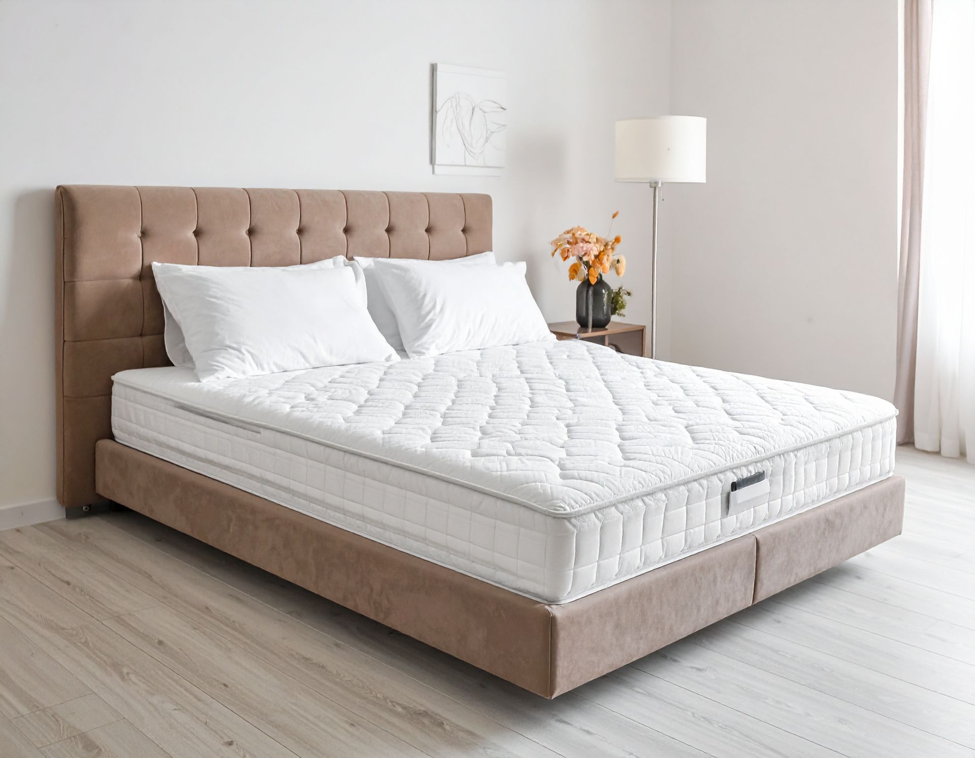 A bedroom with a bed featuring a tufted headboard, white mattress, and pillows.