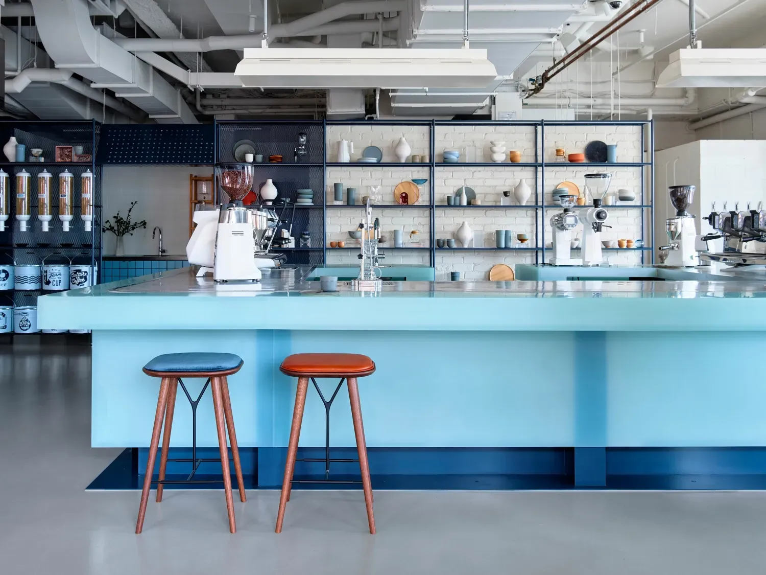 A kitchen with a blue counter top and two stools.