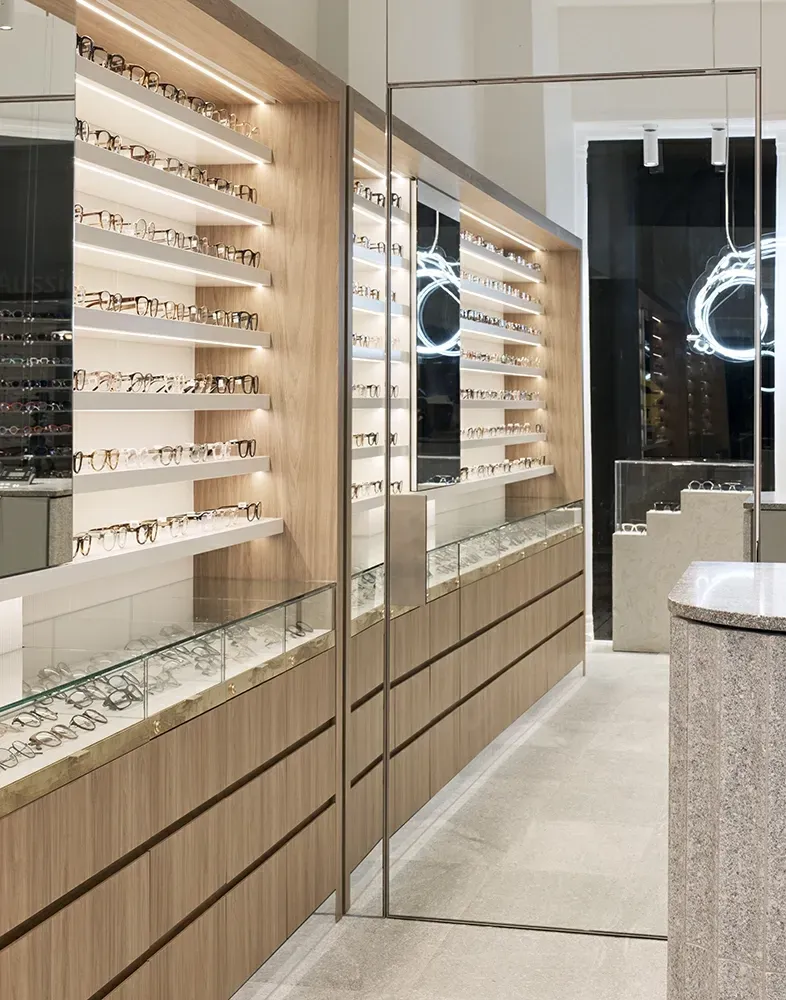 A row of shelves with glasses on them in a store