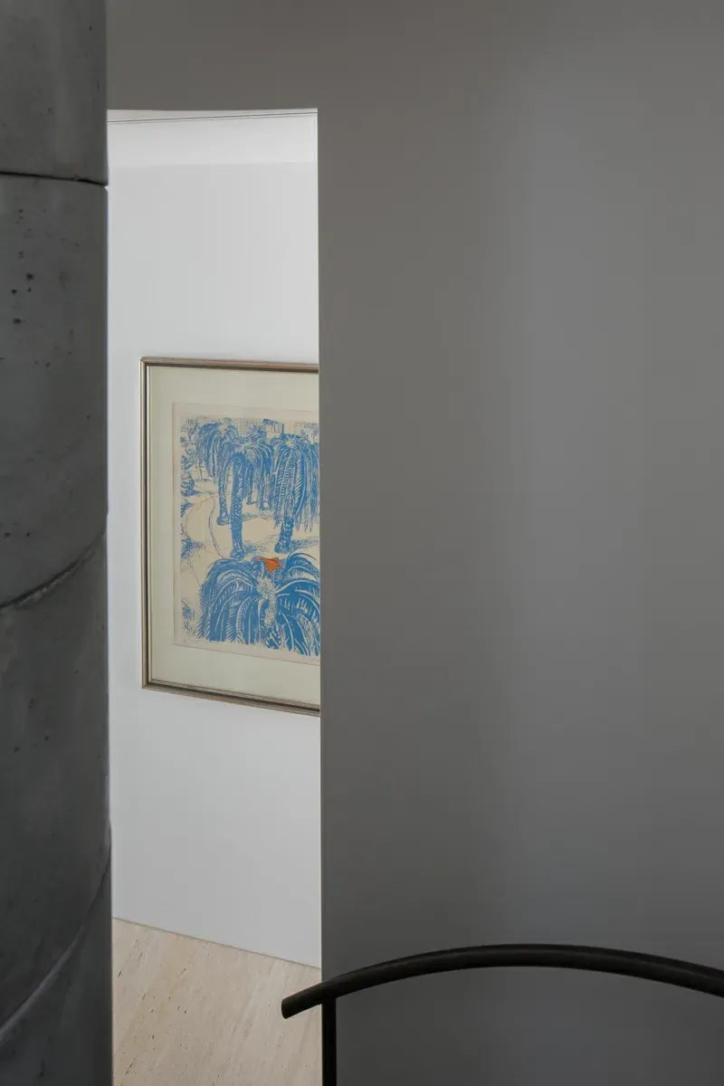 A painting is hanging on a wall in a room.