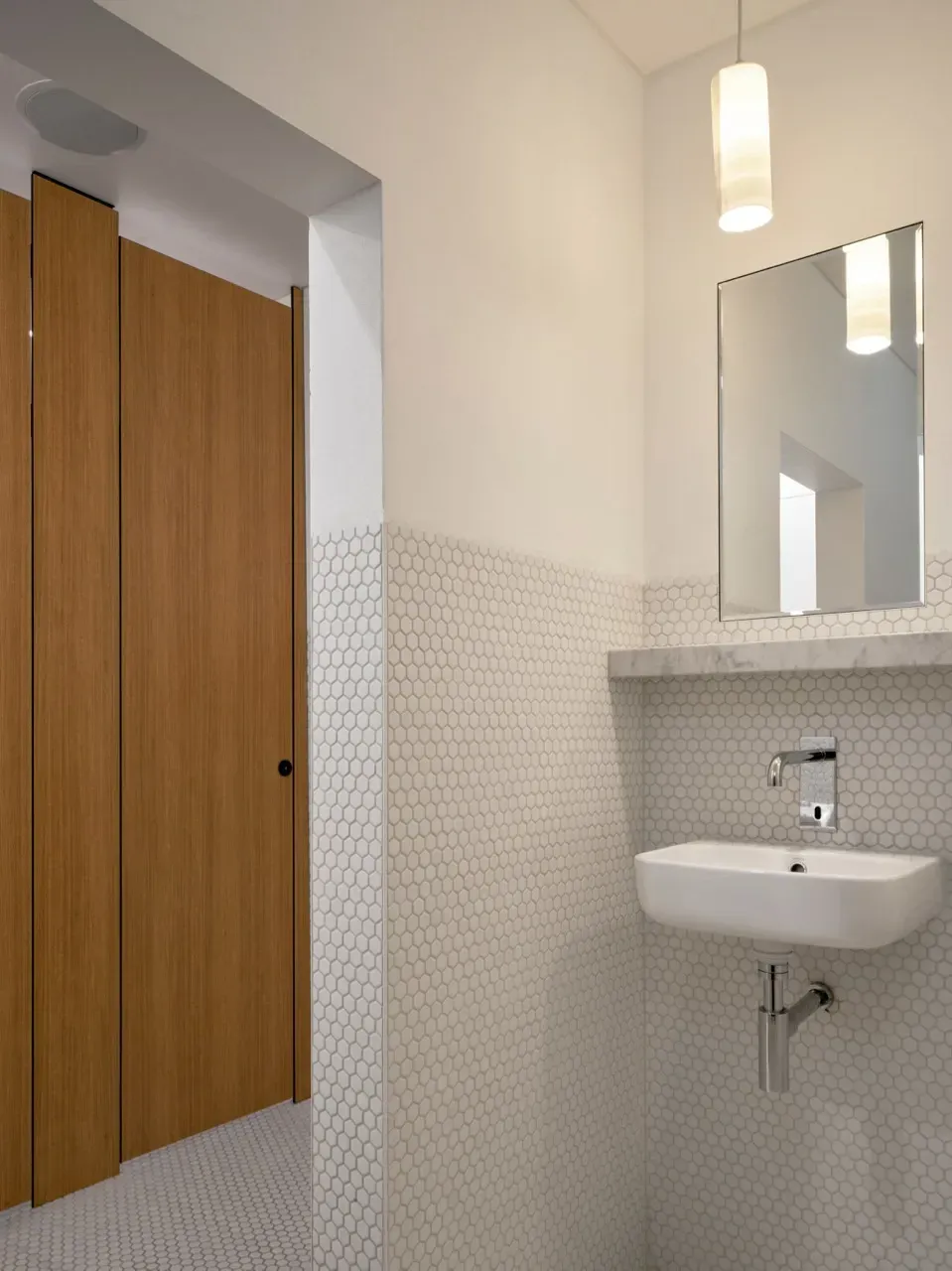 A bathroom with a sink and a mirror on the wall