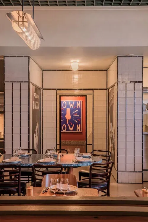 A restaurant with tables and chairs and a sign that says own