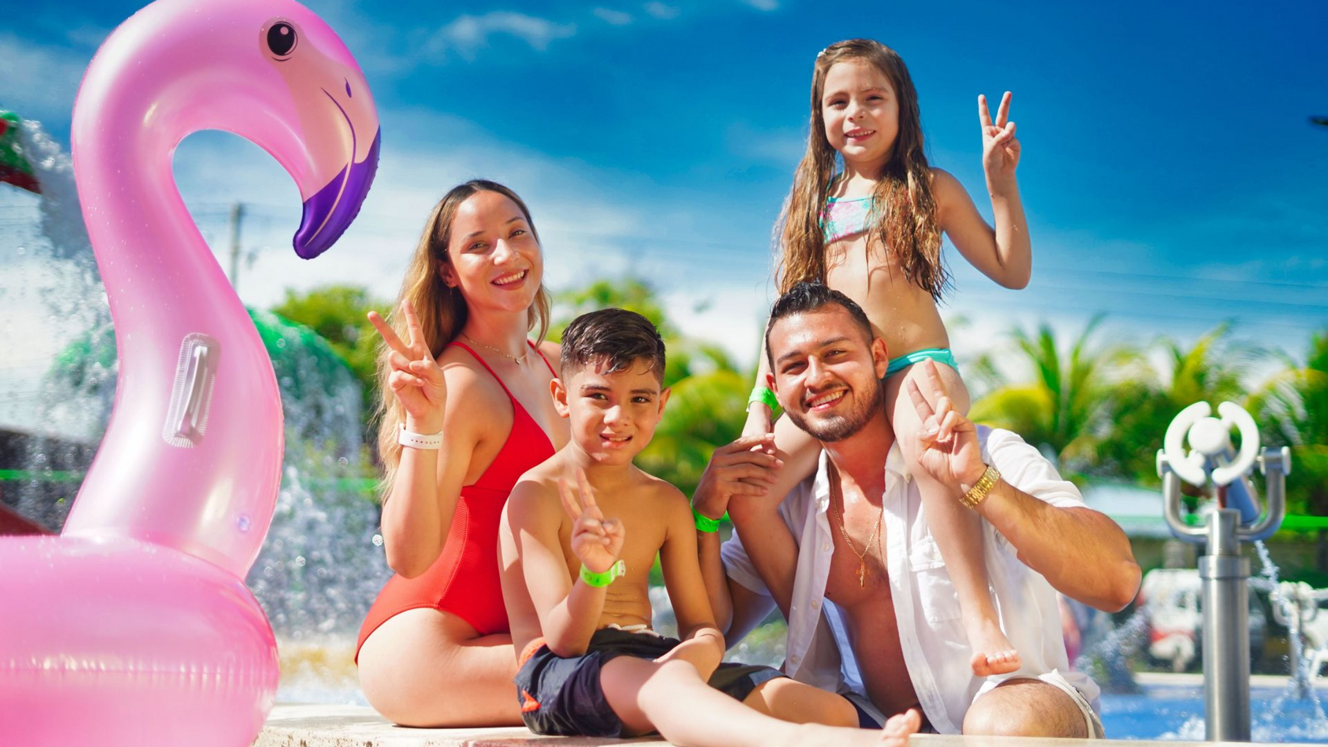 Family by a swimming pool with a pink flamingo float on a sunny day