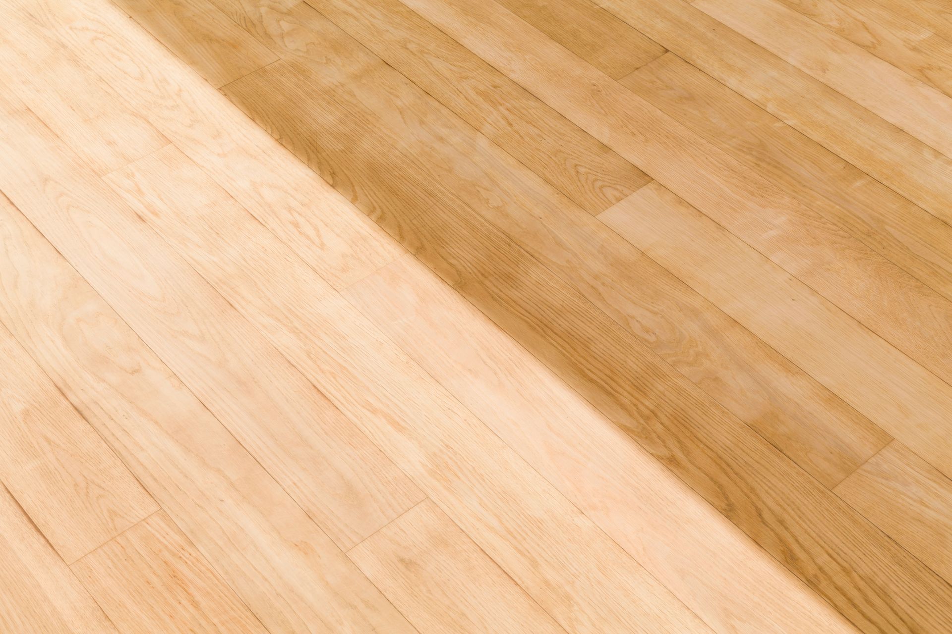 A close up of a wooden floor with a shadow on it