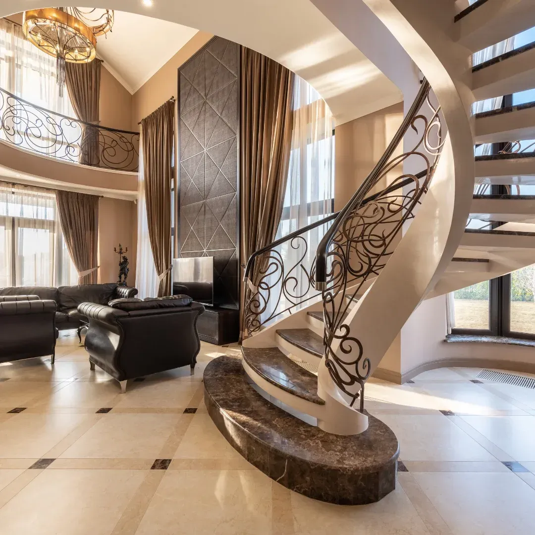There is a spiral staircase in the middle of the living room.