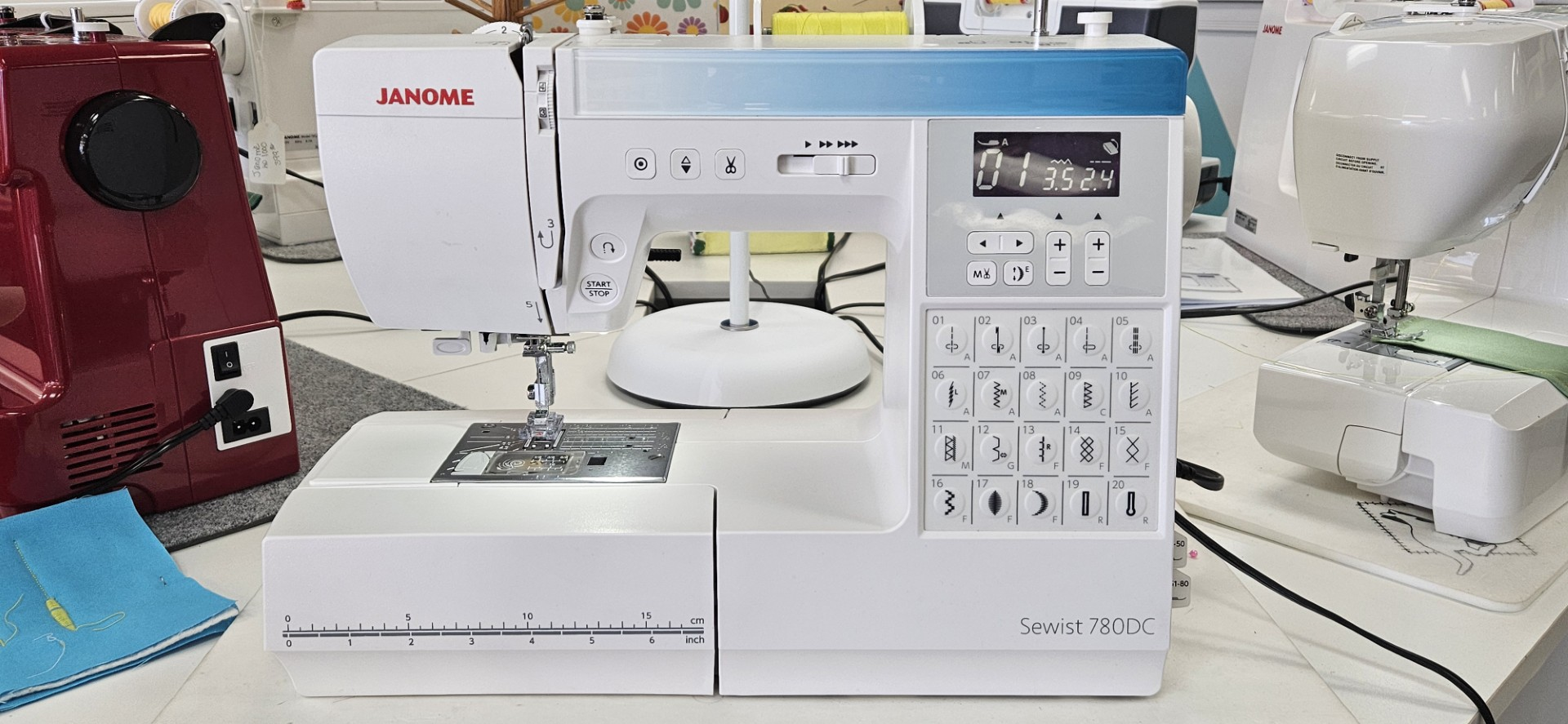 White sewing machine with lavender controls and built-in stitch selection panel on the right