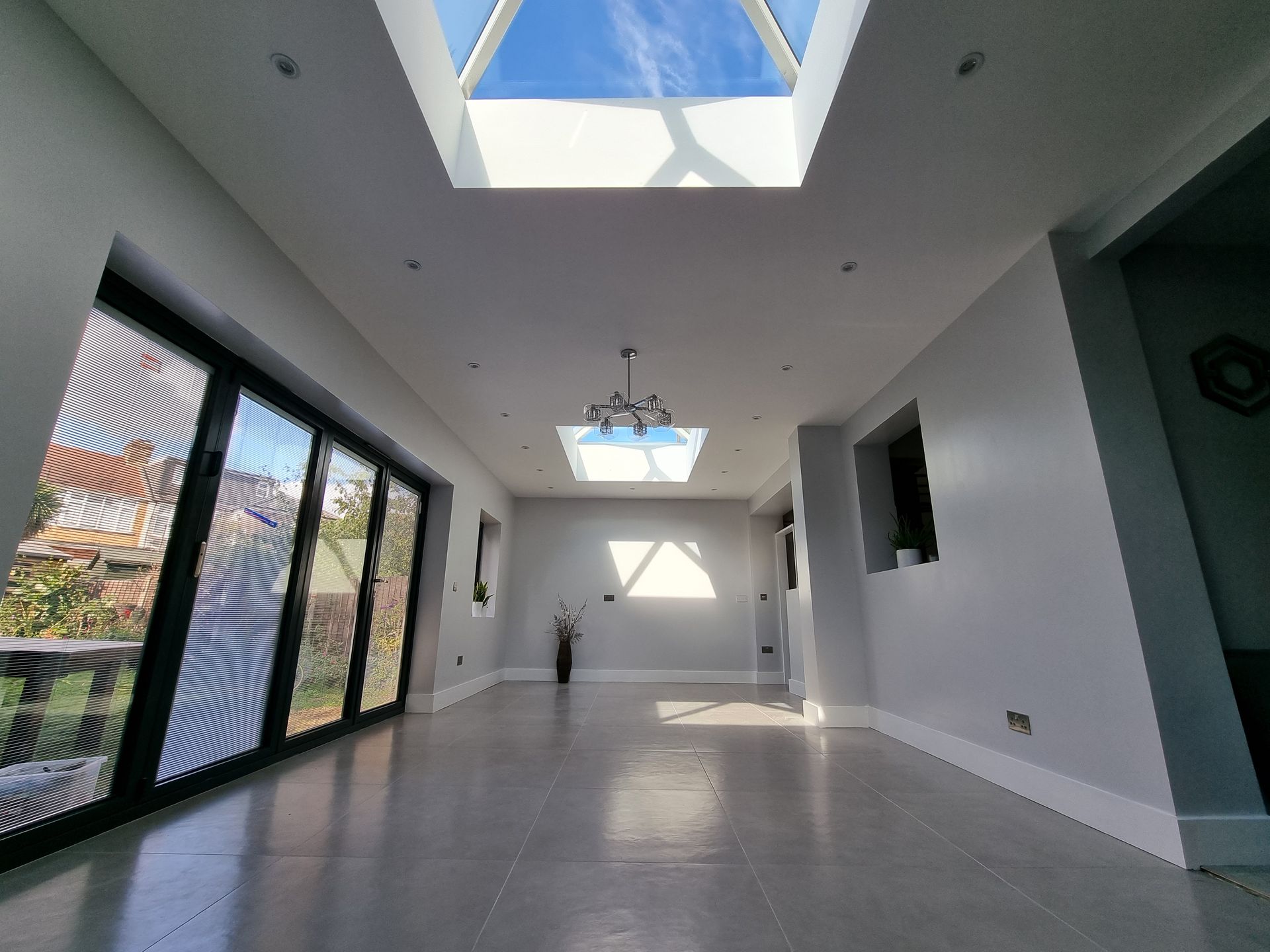 A large empty room with a skylight in the ceiling.