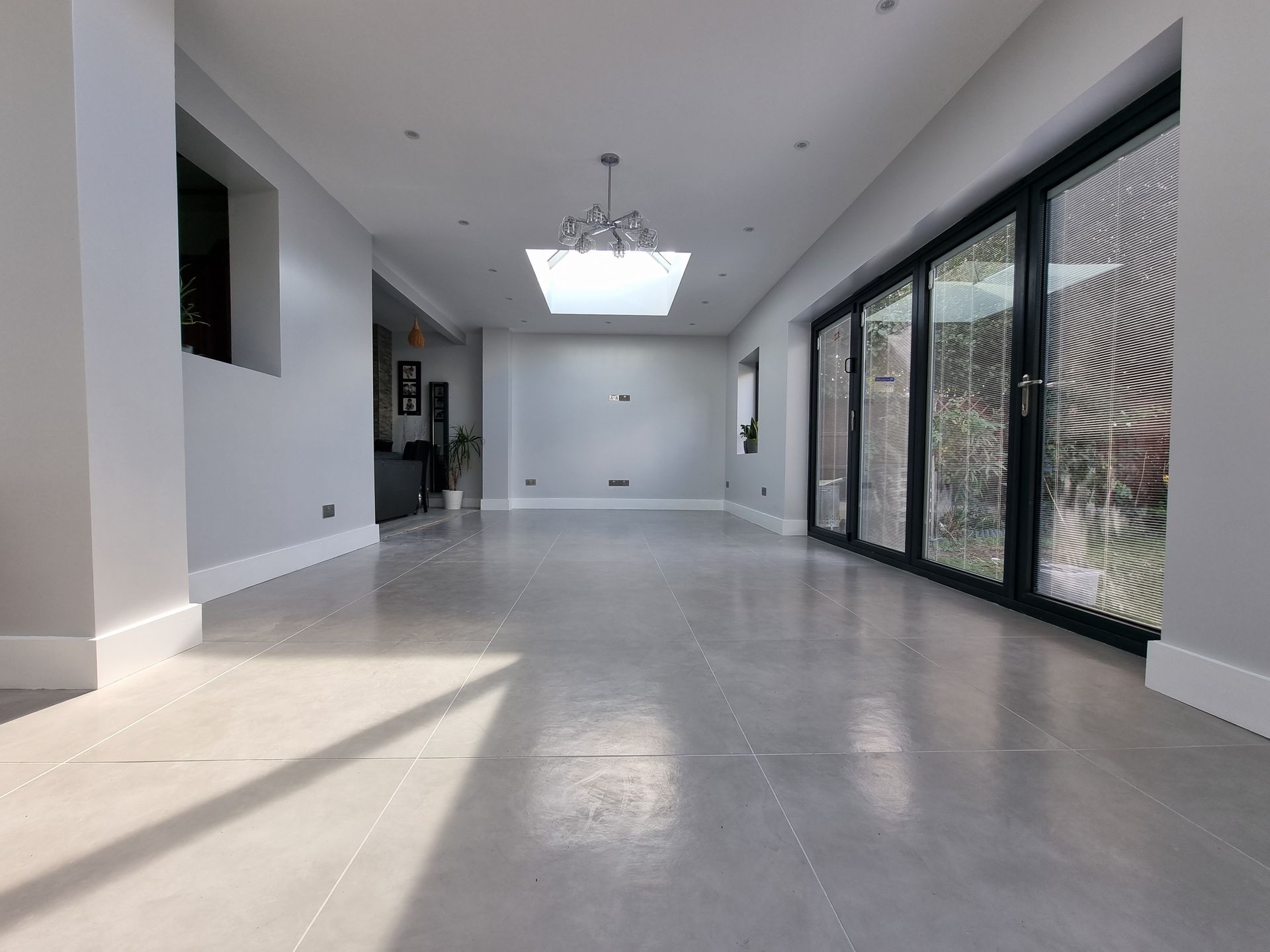 A large empty room with a lot of windows and a skylight in the ceiling.