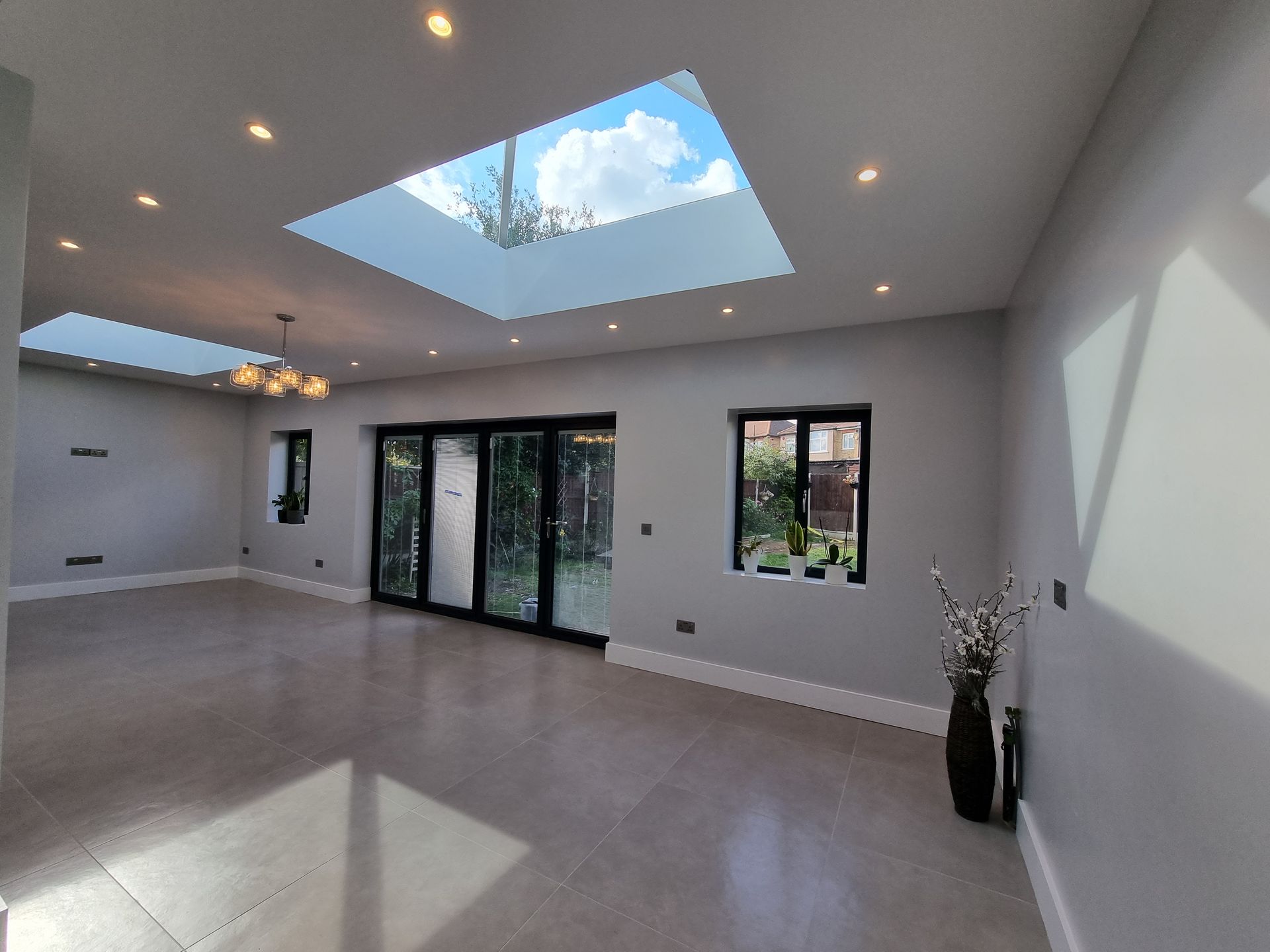 There is a skylight in the ceiling of the living room.