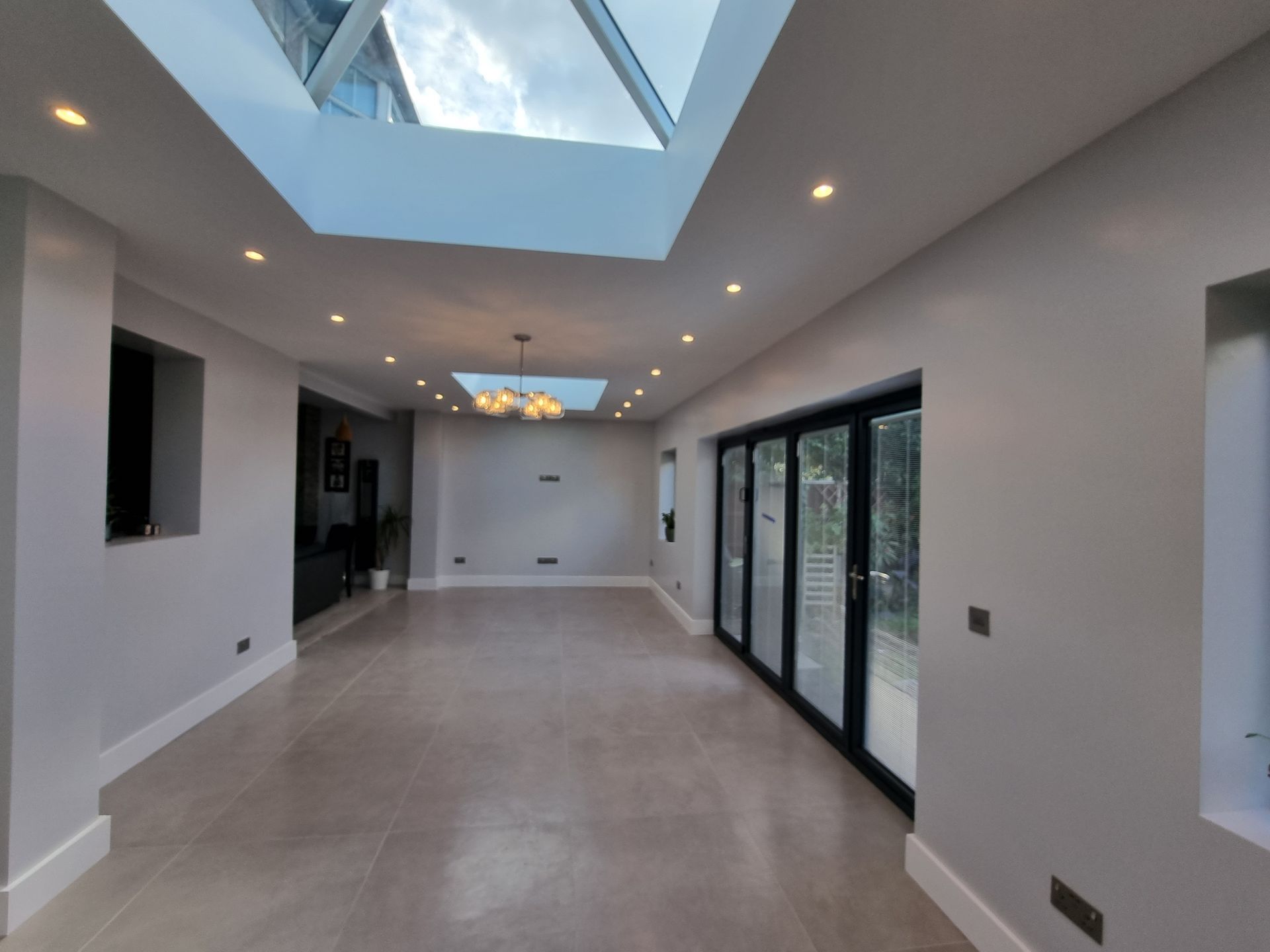 A large empty room with a skylight in the ceiling