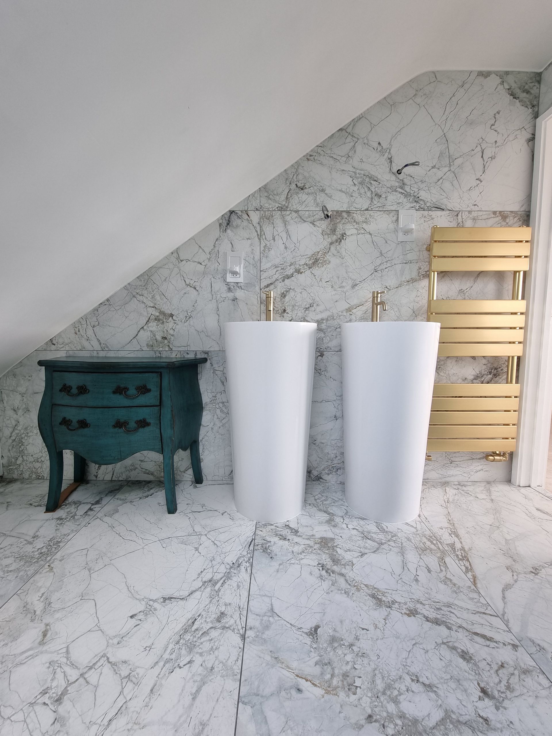 A bathroom with two sinks and a towel rack