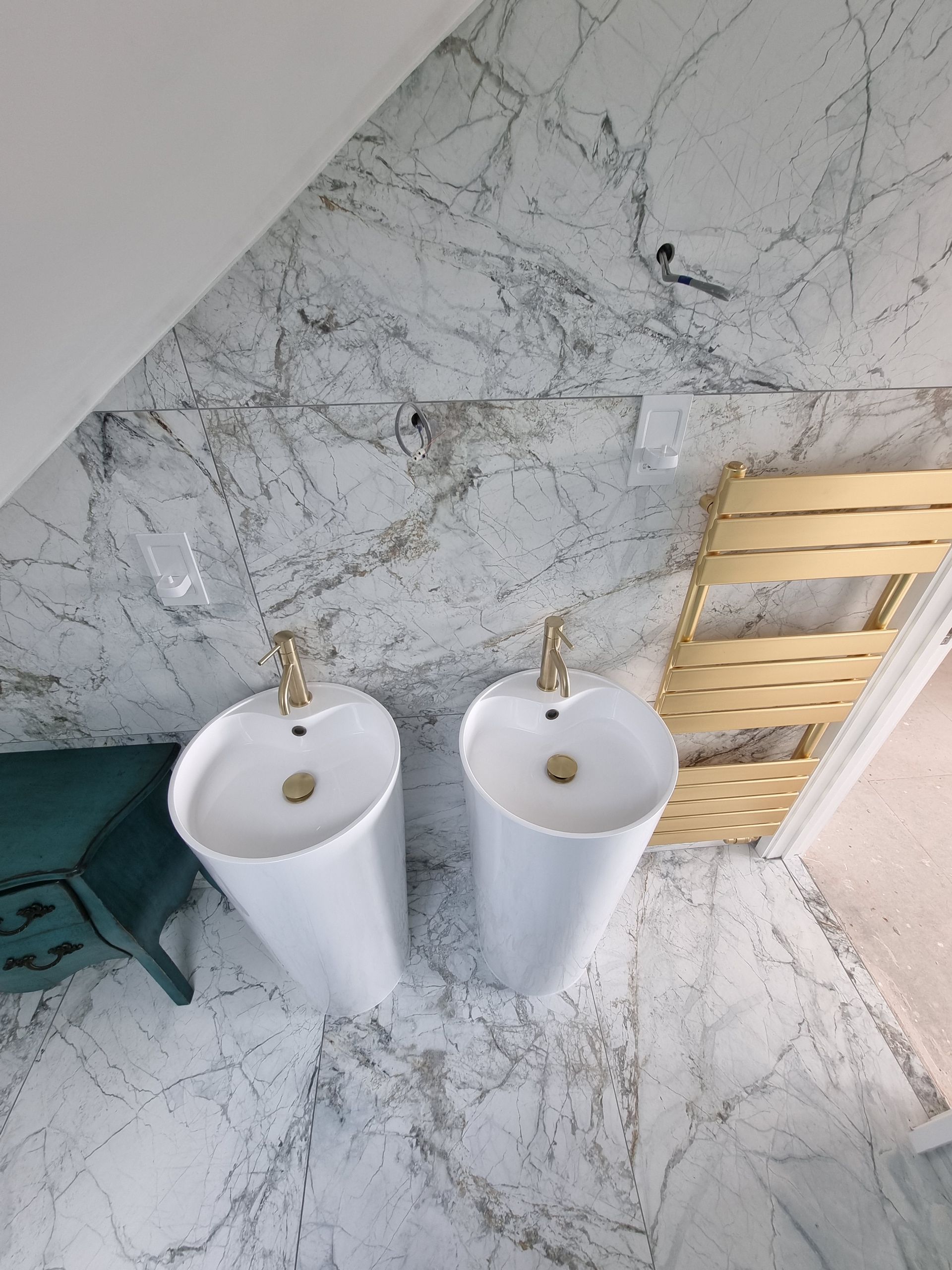 A bathroom with two sinks and a towel rack.