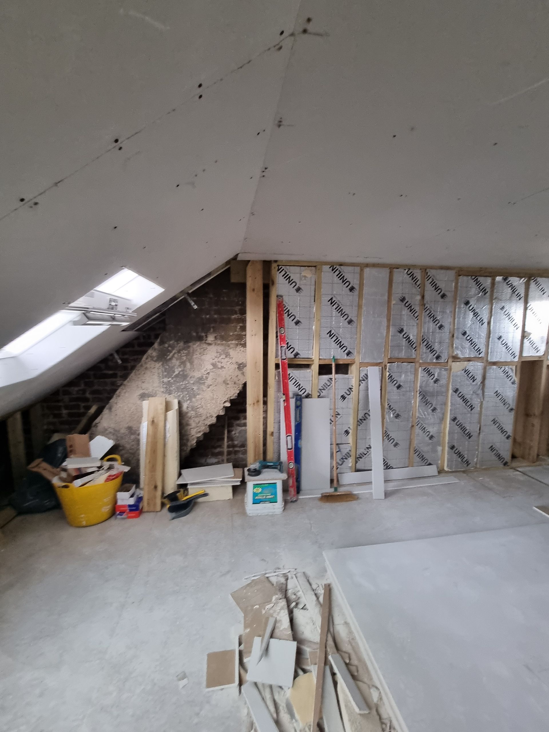 A room that is being remodeled with a lot of boxes on the floor
