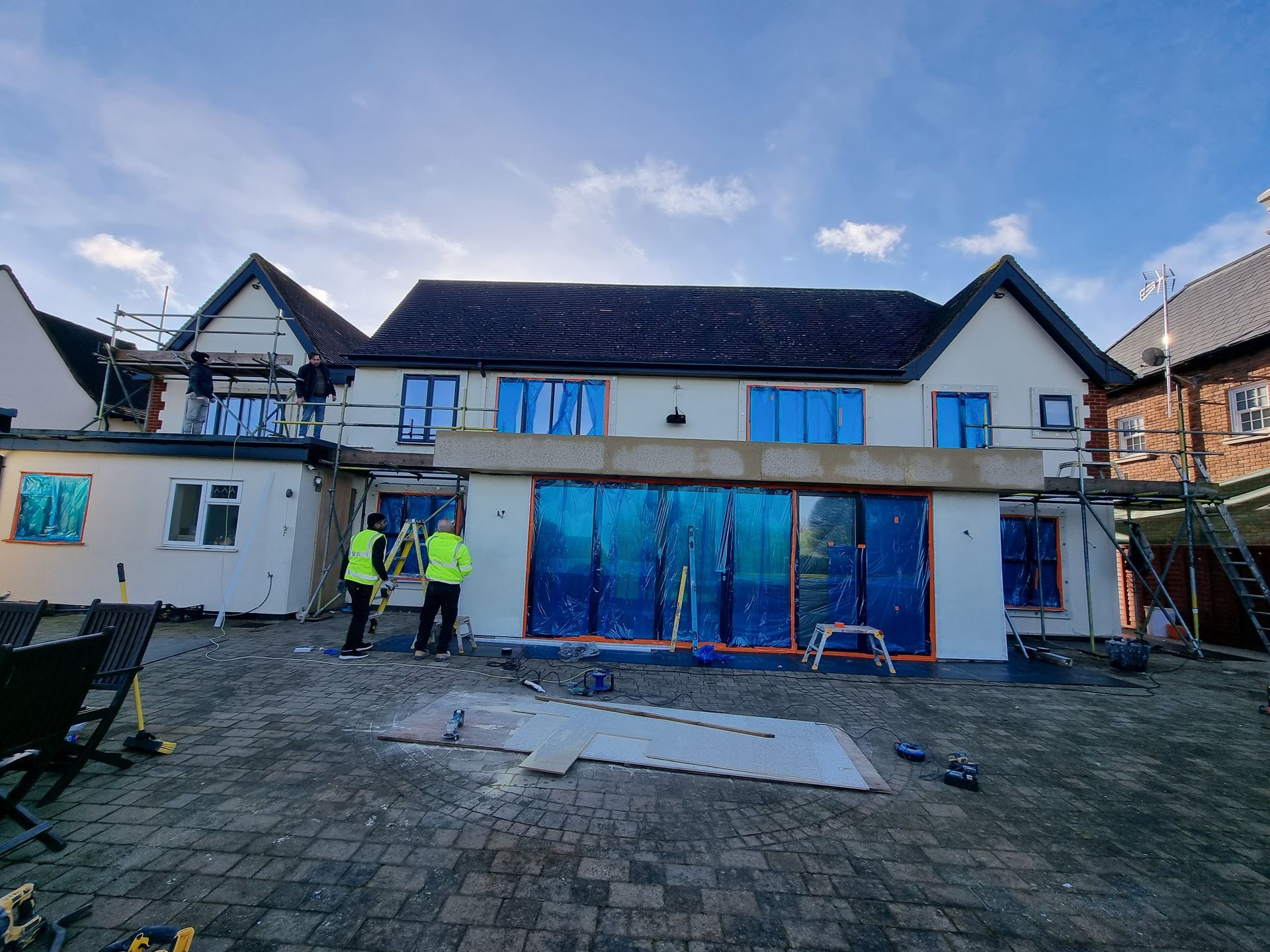 A large house with a lot of windows is being built.