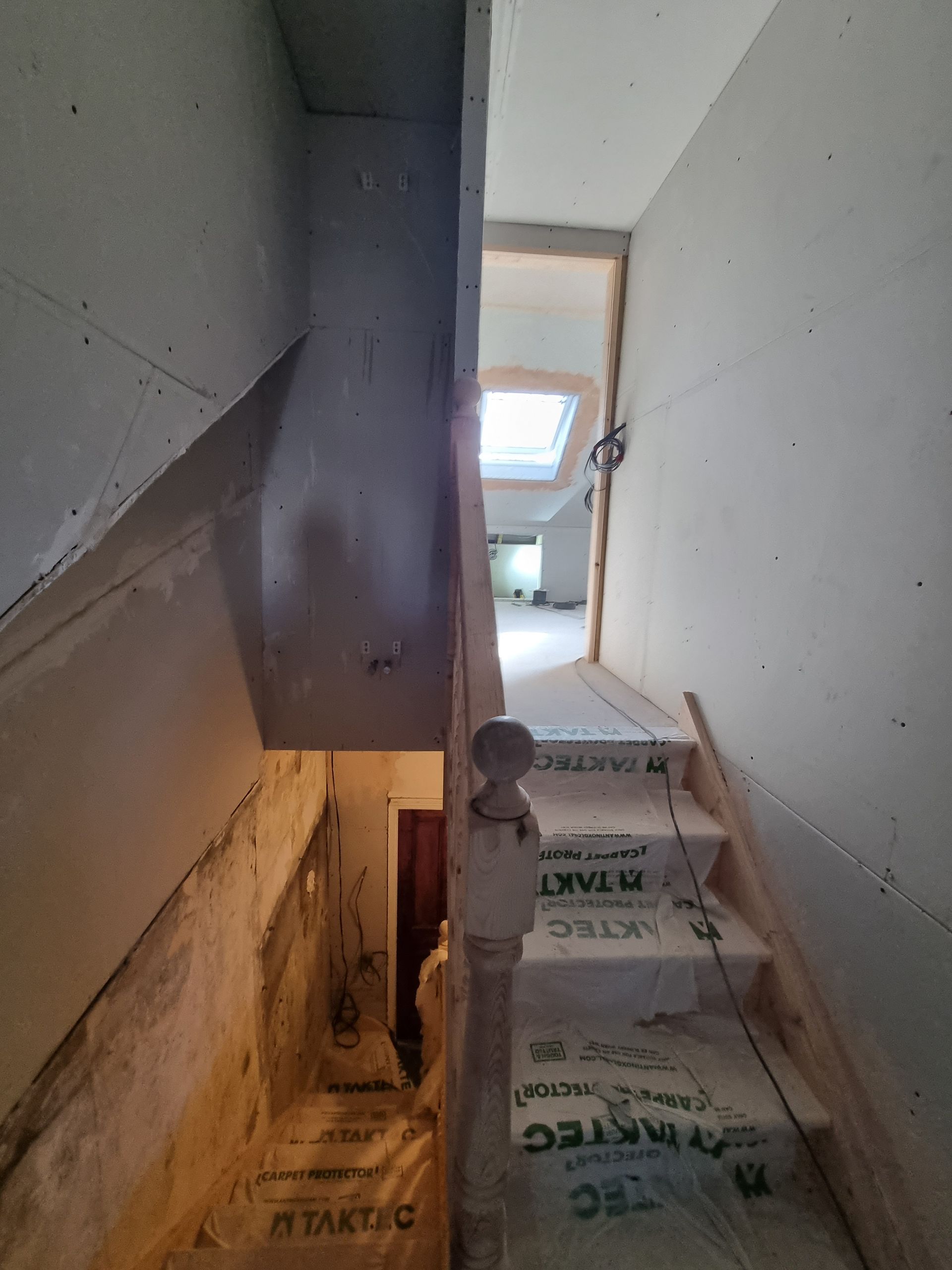 A picture of a staircase in a house under construction.