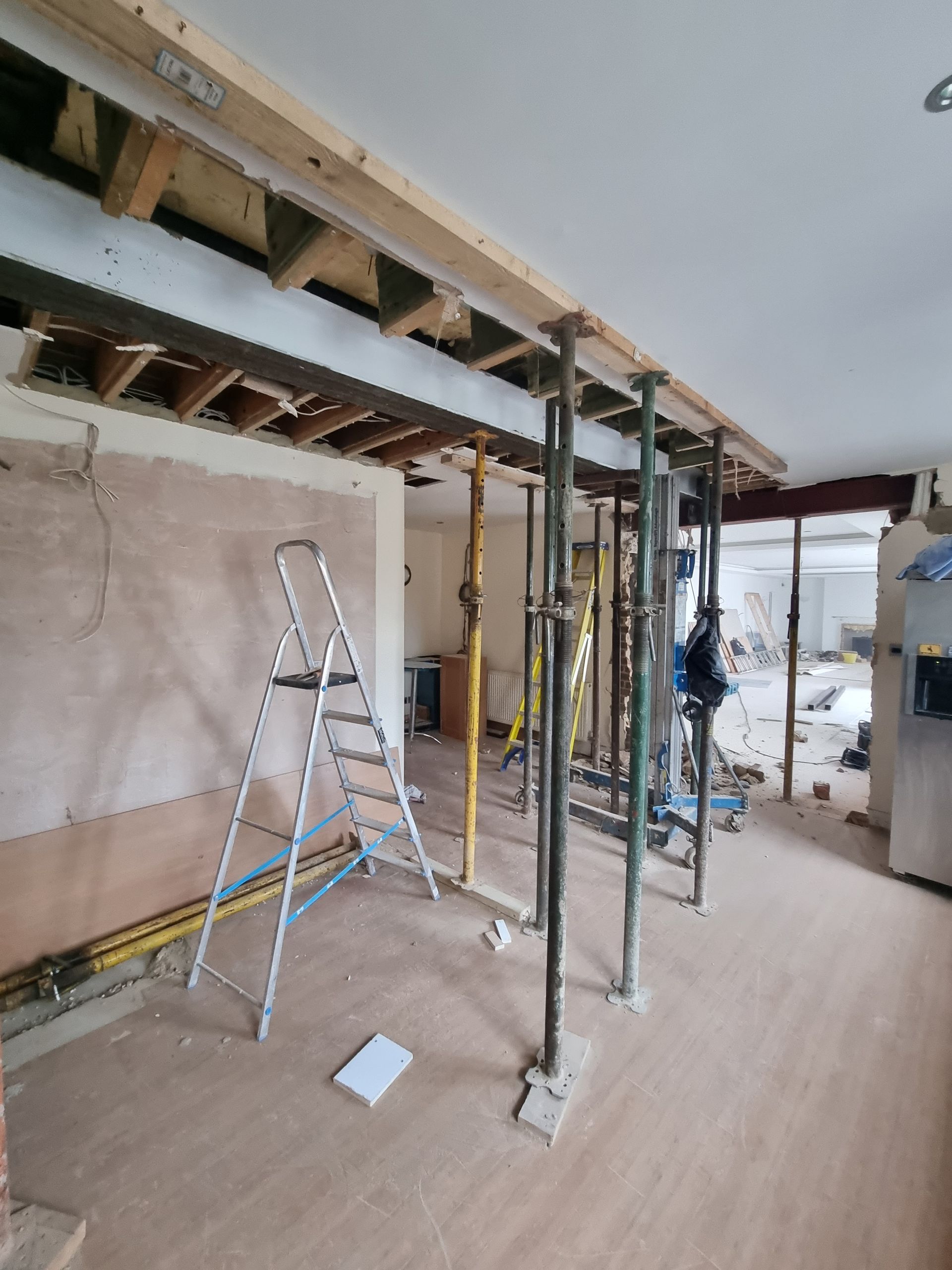 A room under construction with a ladder and scaffolding.