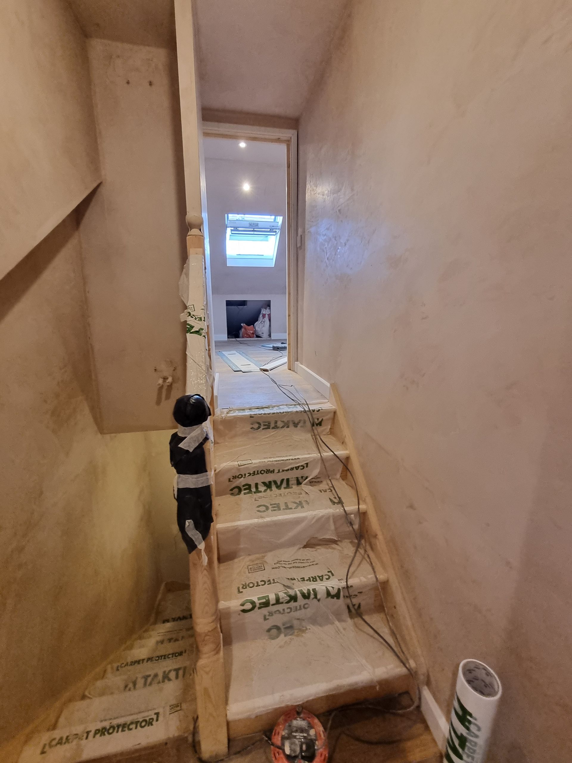 A staircase is being built in a basement.