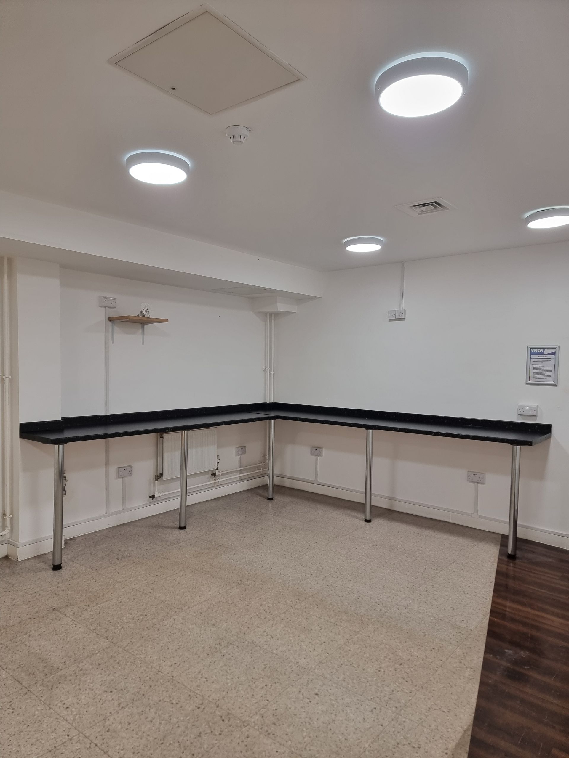 An empty room with a table in the middle of it.