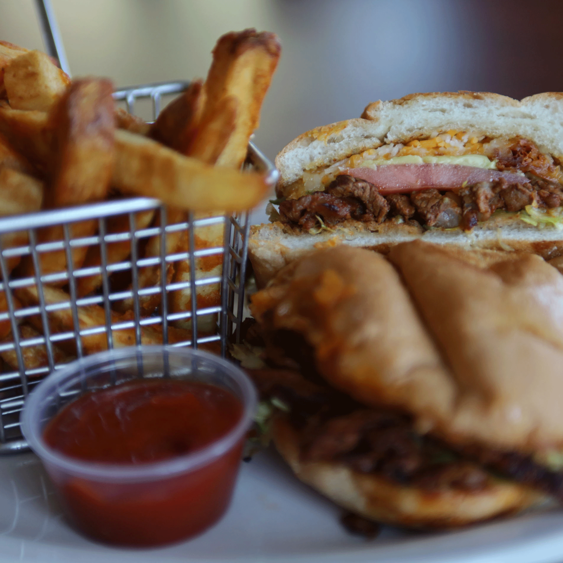 Sandwich with fries and dipping sauce.