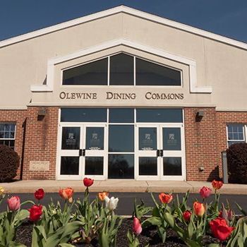 A brick building with the words olewine dining commons on it