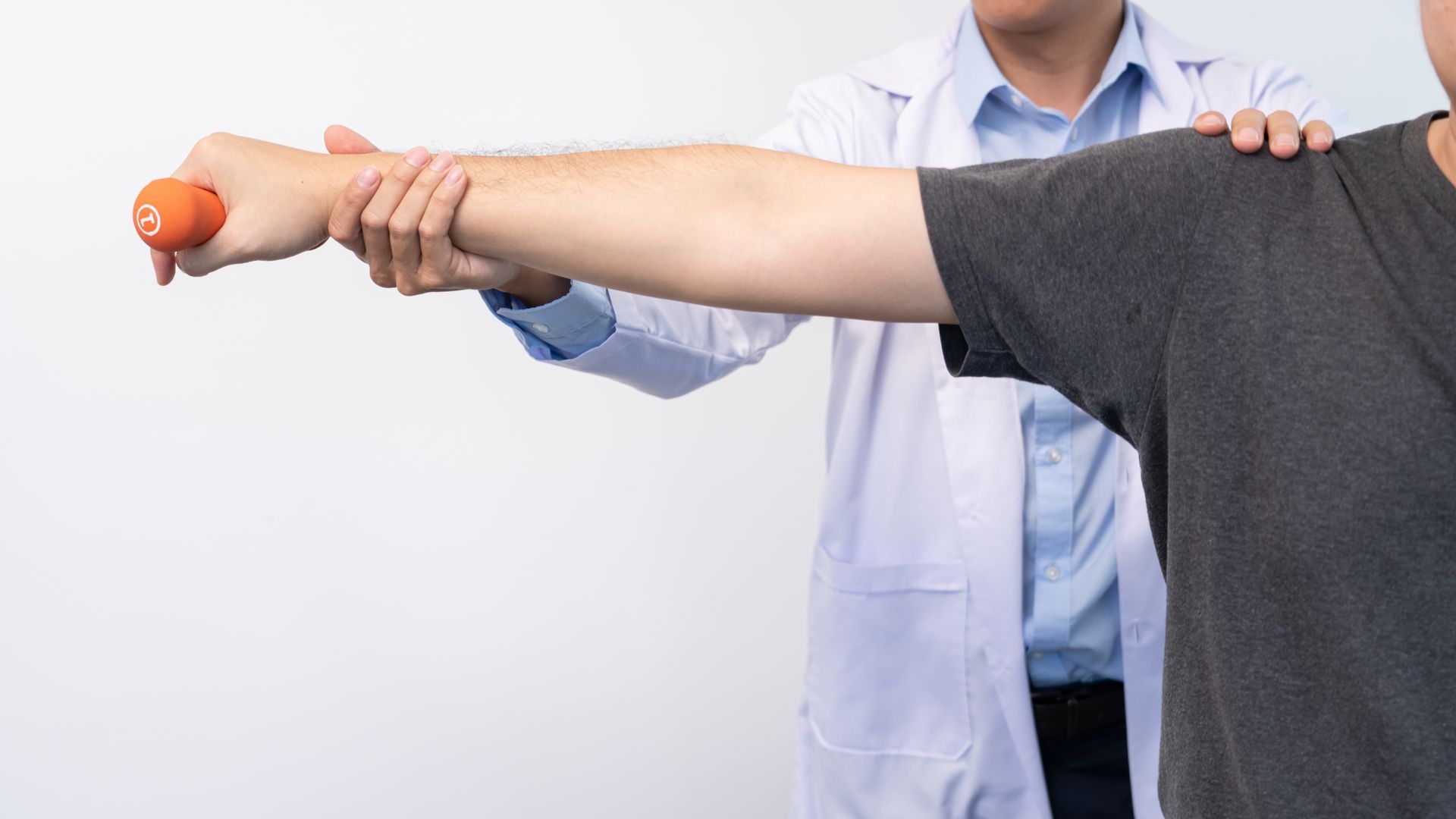 Person comforting another by placing a hand on their shoulder in a bedroom.