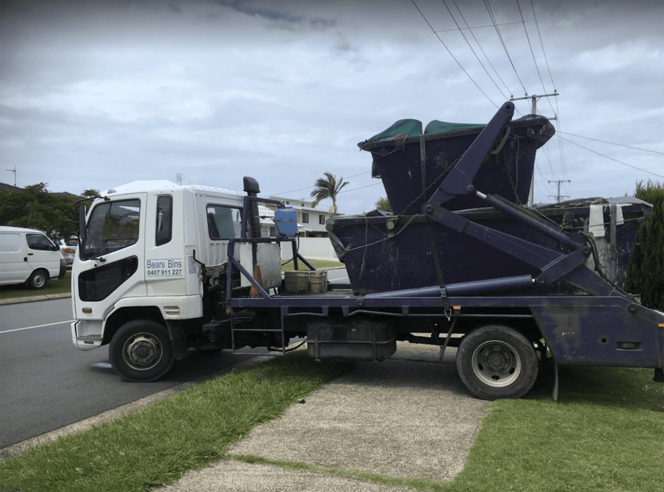 A Truck With A Dumpster On The Back — Bears Bins Skip Hire In Meridan Plains, QLD