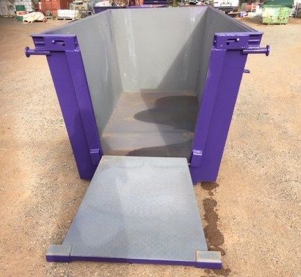 A Large Purple Empty Dumpster Is Sitting In The Middle Of A Dirt Field — Bears Bins Skip Hire In Slippy Downs, QLD