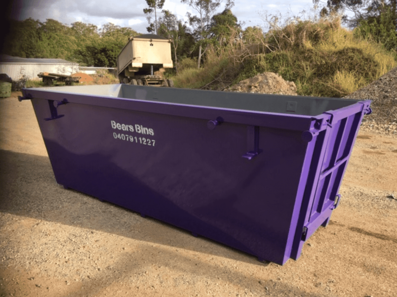 A Red Dumpster Is Parked In Front Of A Building — Bears Bins Skip Hire In Buderim, QLD