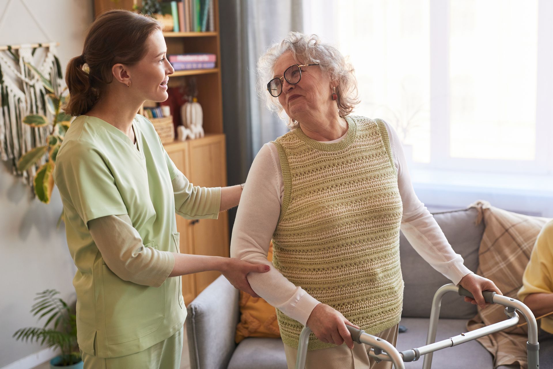 Caregiver helping a senior woman use her walker. Caregiver helping a senior woman use her walker.