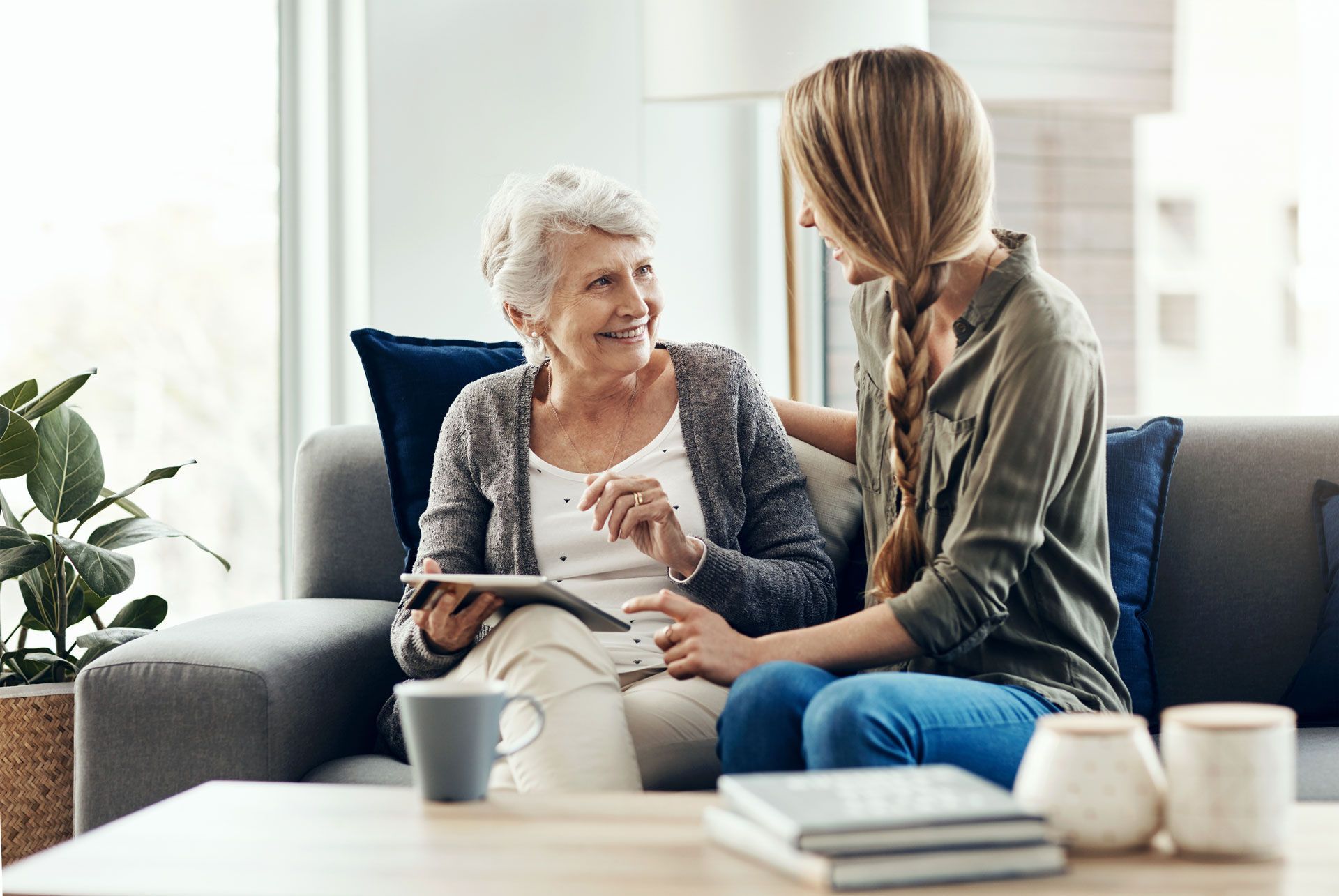 A woman is talking with a senior woman. A woman is talking with a senior woman.