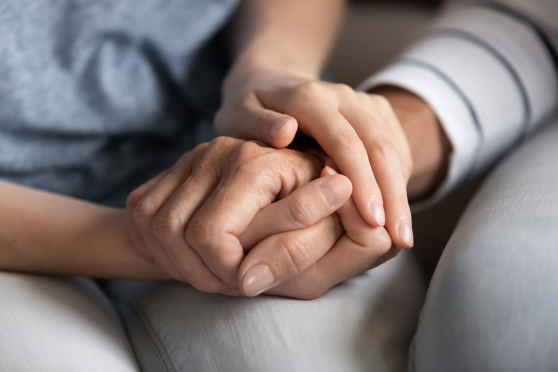 close up of two women holding hands, representing the unity of women during National Infertility Awareness Week