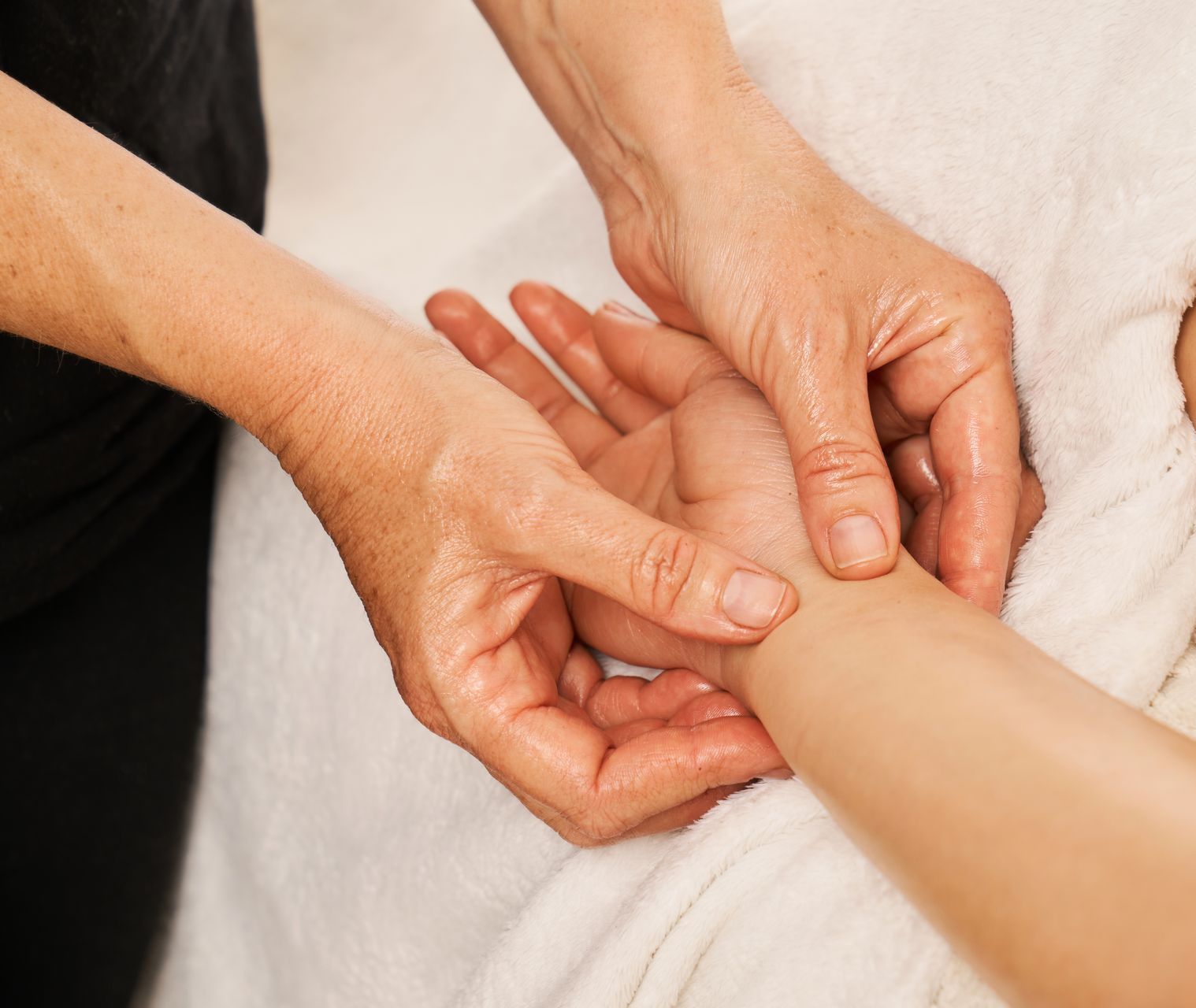 a massage therapist is utilizing pressure points to induce labor