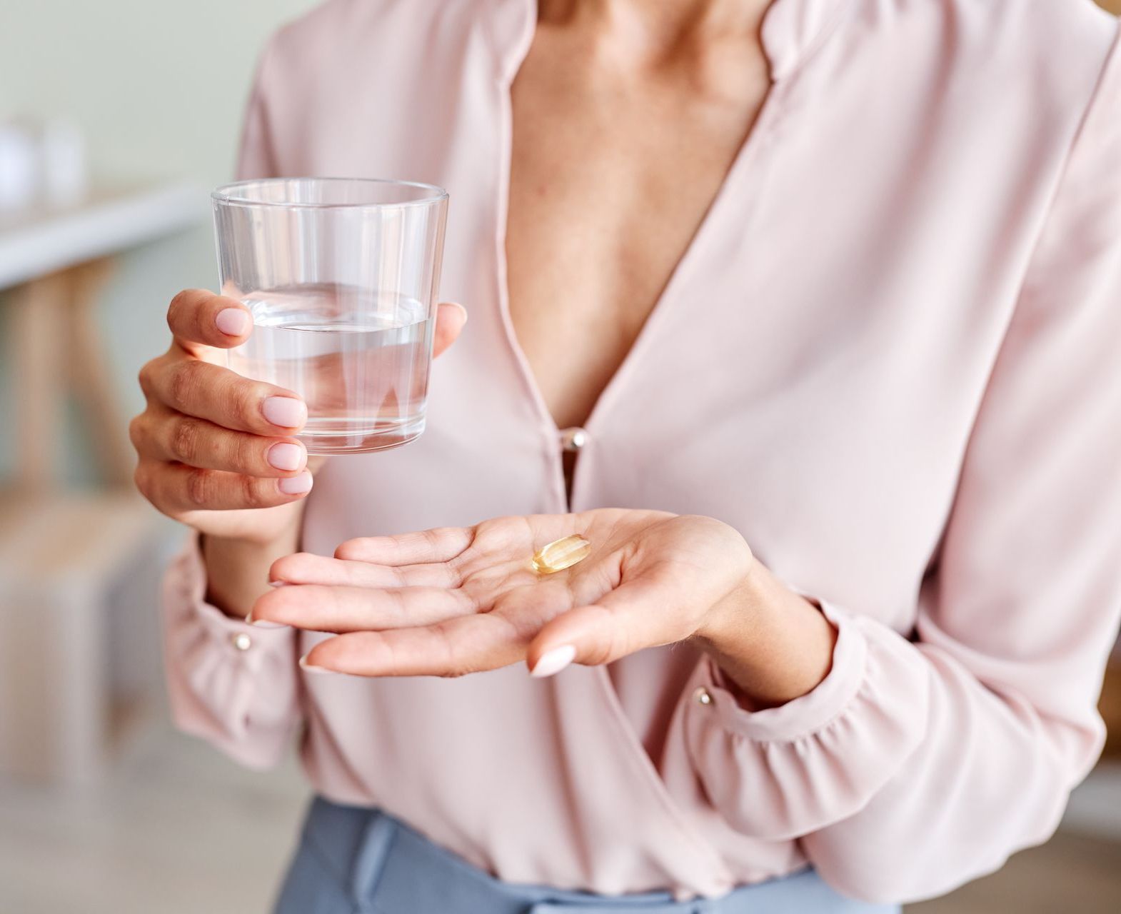 close up of the woman taking supplements to prevent miscarriage