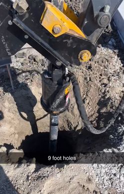 Drilling rig boring a 9-foot hole in rocky ground with black and yellow equipment.