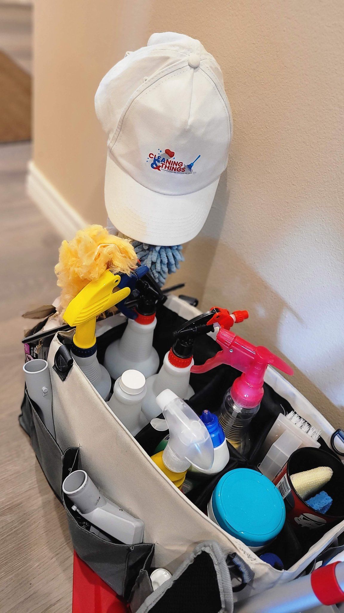 A box filled with cleaning supplies and a hat.
