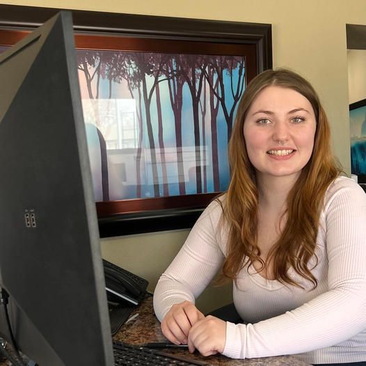 Team Member in Front of Computer Monitor | Auto Quality Sales & Service
