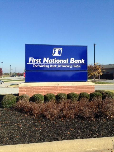 Blue First National Bank sign with white text reading 