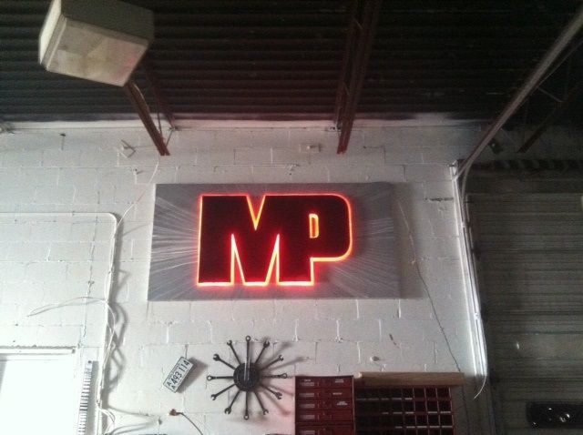 An illuminated sign with the letters 