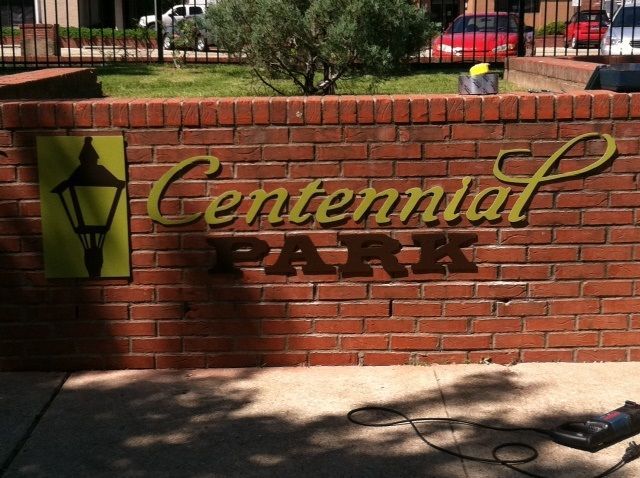 A brick wall sign reads 