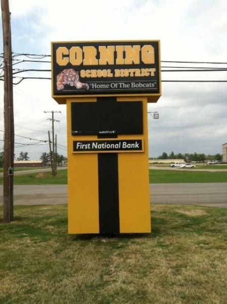 A yellow and black Corning School District sign, 
