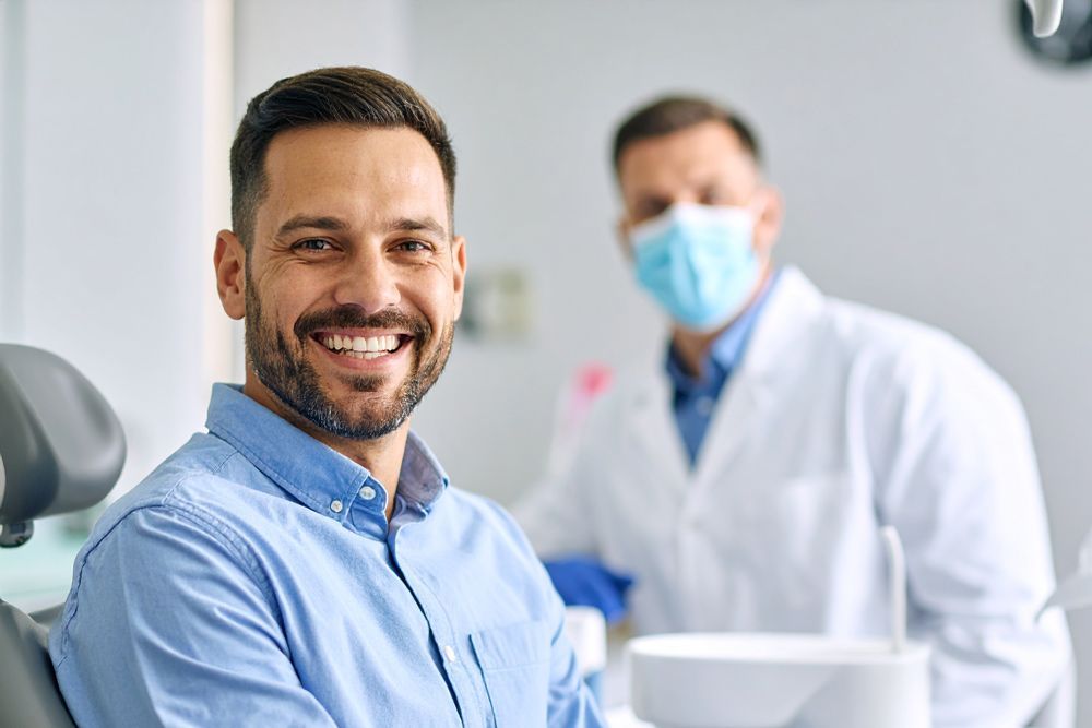 Man smiles in dentist's chair in Meridian, ID