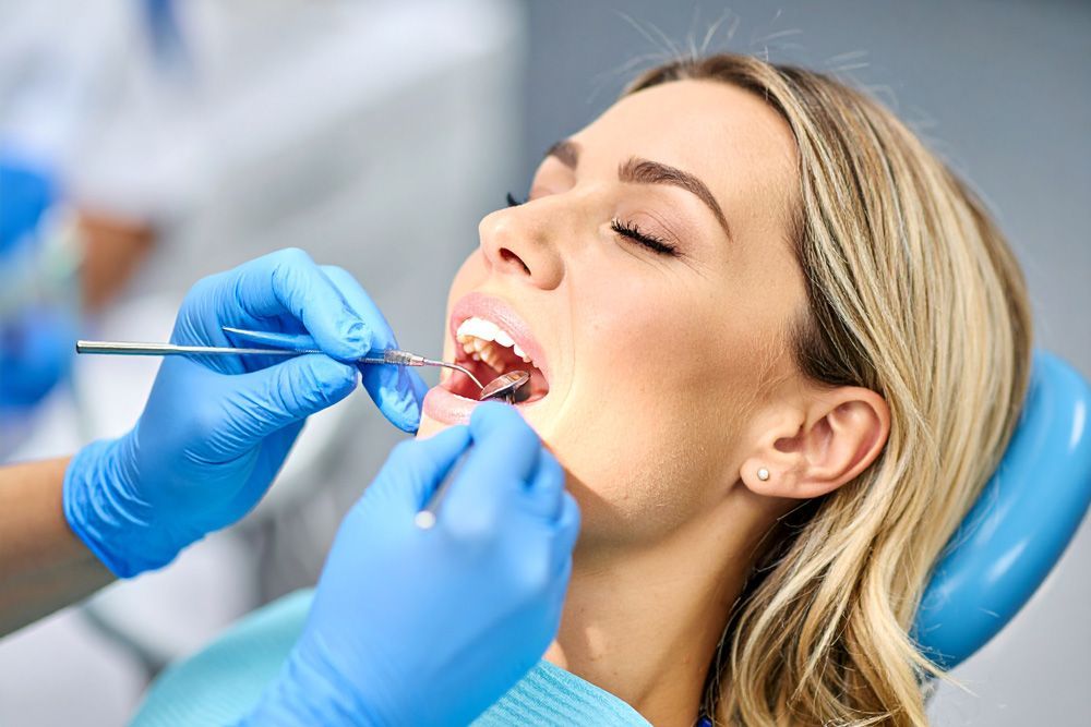 Woman in dental chair having teeth examined by a dentist in Meridian, ID
