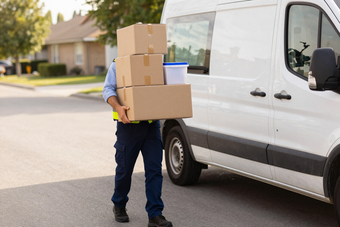 Worker carrying assorted goods for delivery
