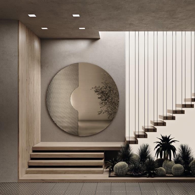 Specchio circolare su una parete sopra una scala con piante; toni neutri e design moderno.