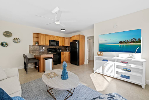 A living room with a coffee table and a flat screen tv.