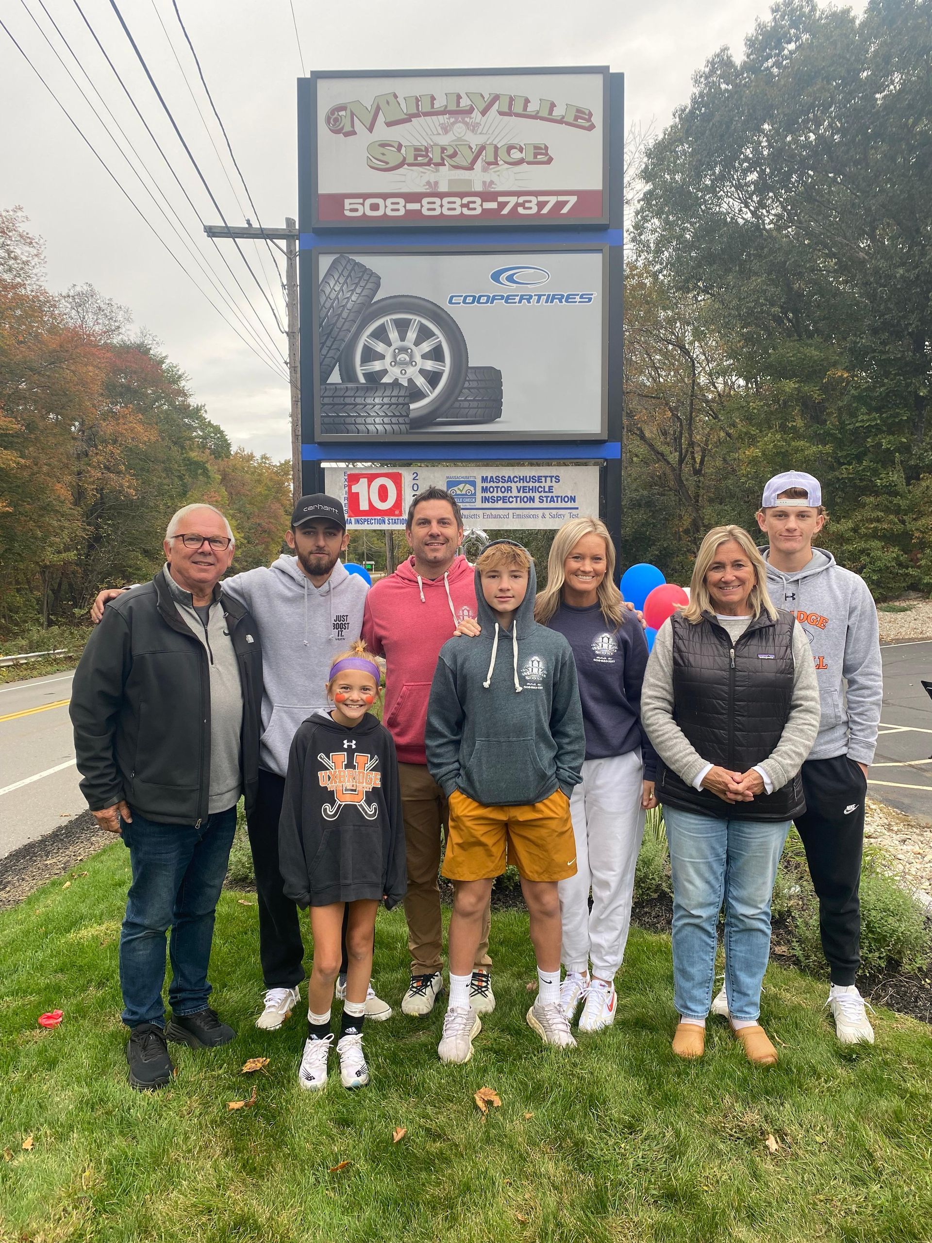 Team Standing Outside Millville Service Sign | Millville Service