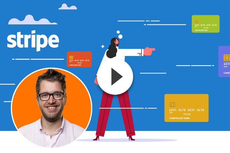 A man is standing in front of a video of a woman pointing at a credit card.
